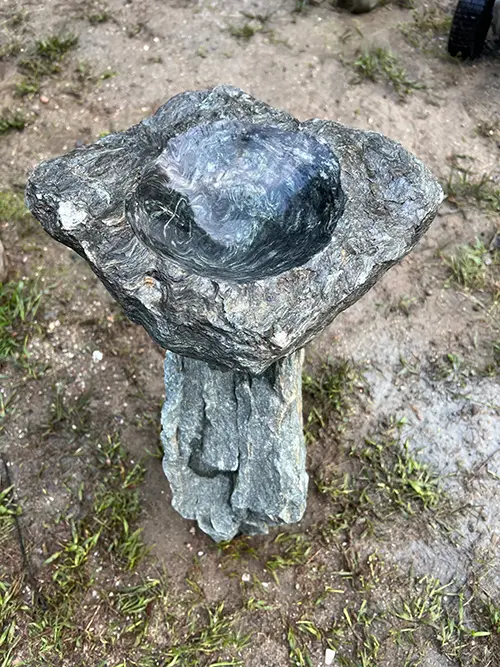 Stone bird bath sculpture
