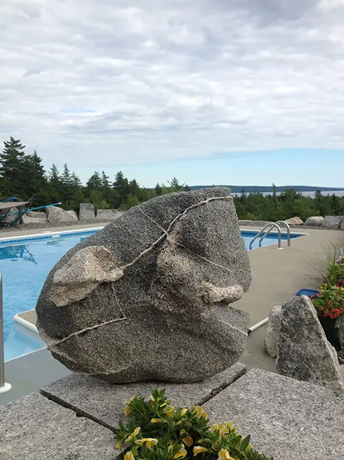 Stone sculpture by swimming pool