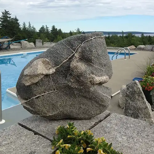 Stone sculpture beside swimming pool